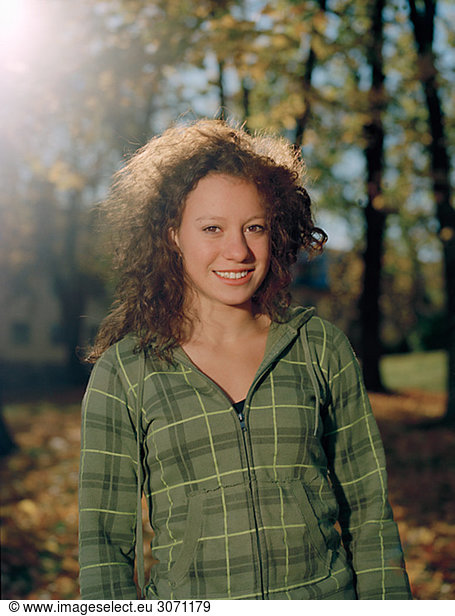 Portrait of a smiling teenage girl in the autumnal sun Sweden.