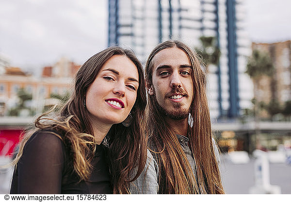 Portrait of a smiling young couple in the city