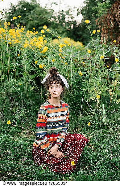 Portrait of a smily hippie woman wearing colorful clothes holdi