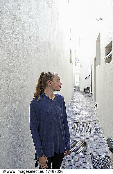 Portrait of a teenage girl in a narrow alleyway in the old town of Cape Town.