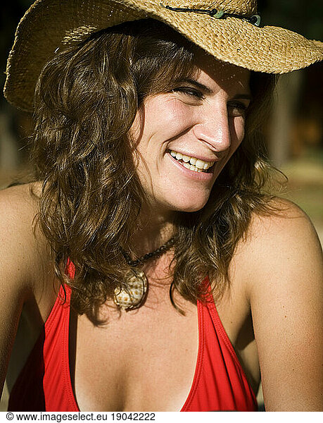 Portrait of a woman in cowboy hat and bikini outdoors.