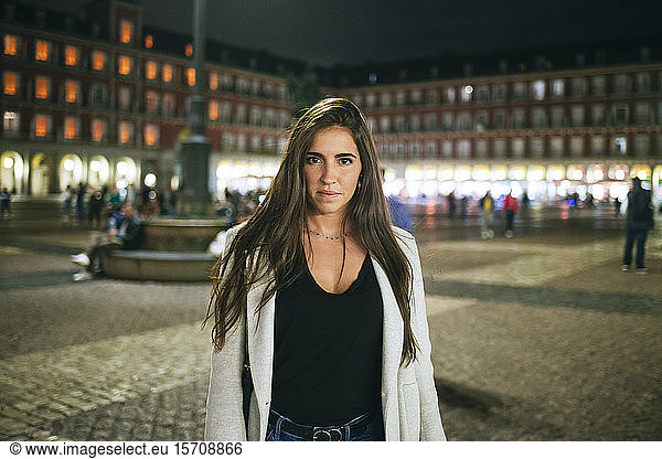 Portrait of a woman standing on Plaza Mayor at night  Madrid  Spain