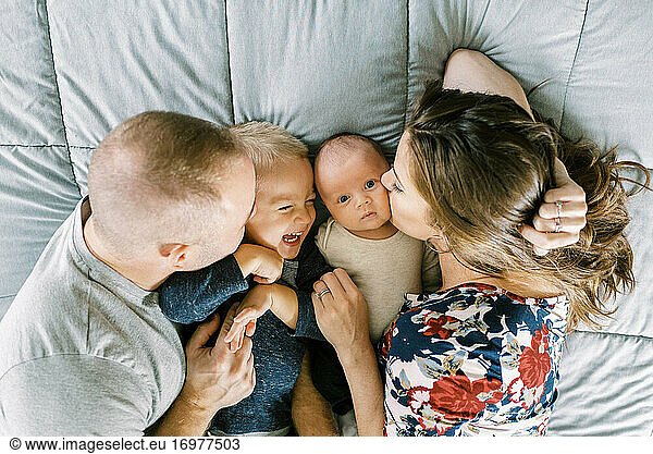 Portrait of a young family with a newborn baby boy and toddler