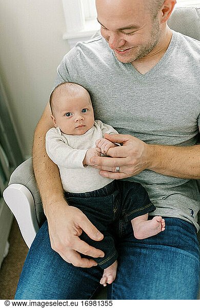 Portrait of a young father and his newborn baby boy