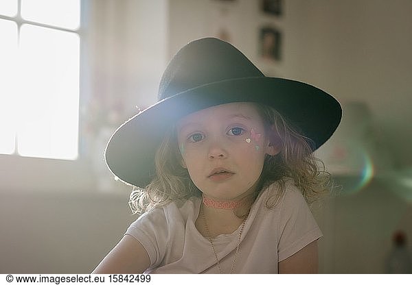 portrait of a young girl in fancy dress in her room at sunset