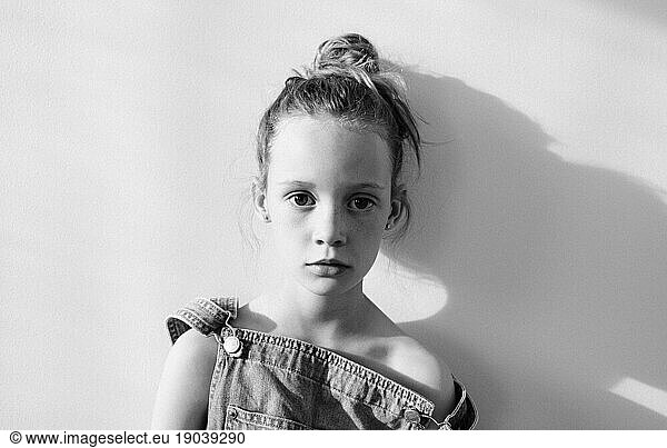 portrait of a young girl with freckles looking into the camera