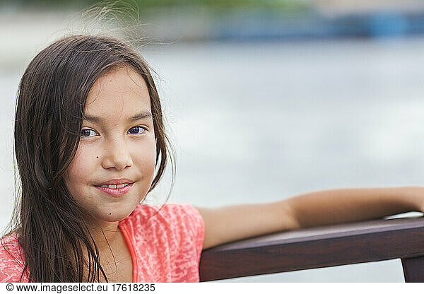 Portrait of a young girl with long brunette hair and brown eyes; Bangkok  Thailand
