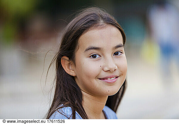 Portrait of a young girl with long brunette hair and brown eyes; Hong Kong  China