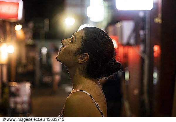Portrait of a young woman admiring the streets of Tokyo  Japan