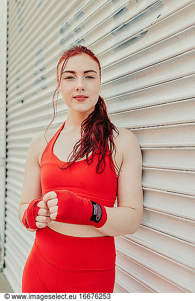 Portrait of a young woman boxer training outdoors in Brooklyn street