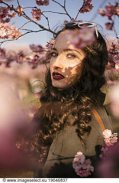 Portrait of a young woman in cherry blossom