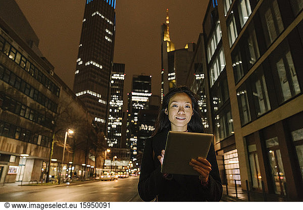 Portrait of a young woman in the city at night  Frankfurt  Germany