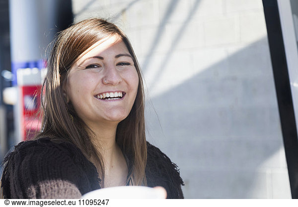 Portrait of a young woman smiling  Freiburg im Breisgau  Baden-Württemberg  Germany