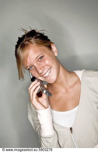 Portrait of a young woman talking on a mobile phone