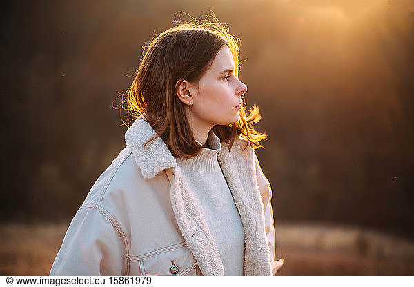 Portrait of a young woman with a sunset
