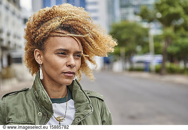 Portrait of a young woman with afro hairstyle in the city
