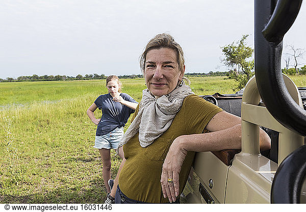 portrait of adult woman leaning on safari vehicle  Botswana