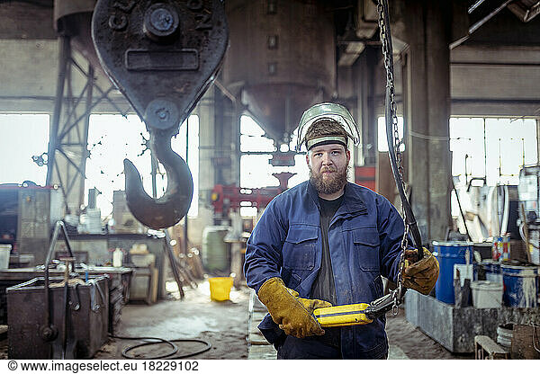 Portrait of apprentice foundry worker in iron foundry