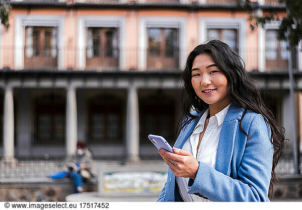 Portrait of Asian businesswoman with her mobile phone.