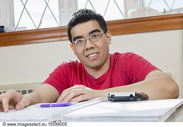 Portrait of Asian man with Autism working in his home