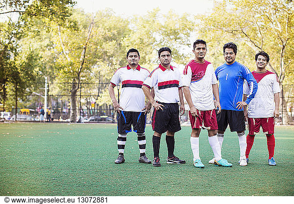Portrait of athletes standing at soccer field
