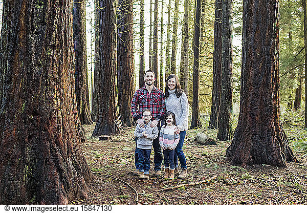 portrait of attractive family in the forest.