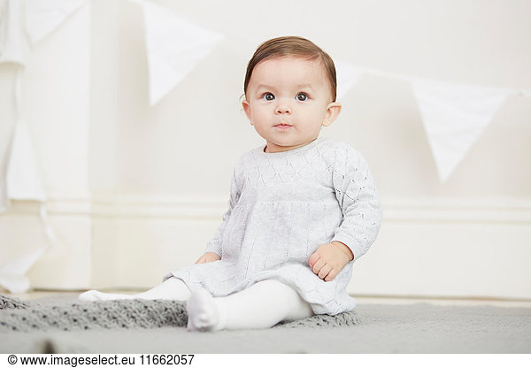 Portrait of baby girl  sitting on blanket