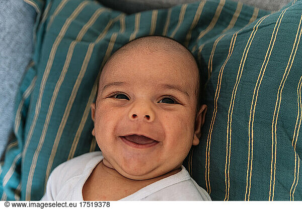 Portrait of baby smiling. Lying on the sofa