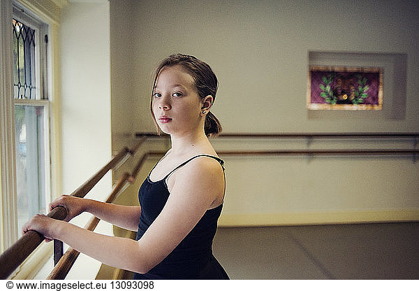Portrait of ballet dancer standing at dance studio