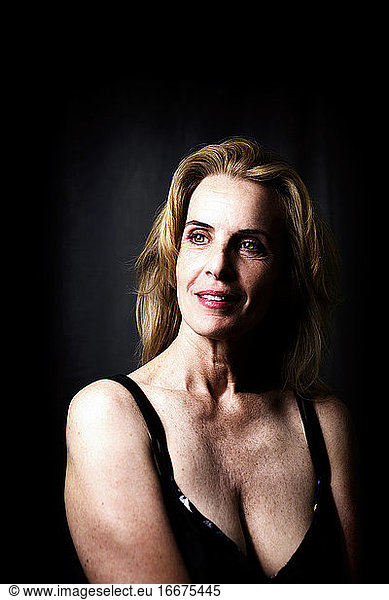 portrait of beautiful mature woman on dark background