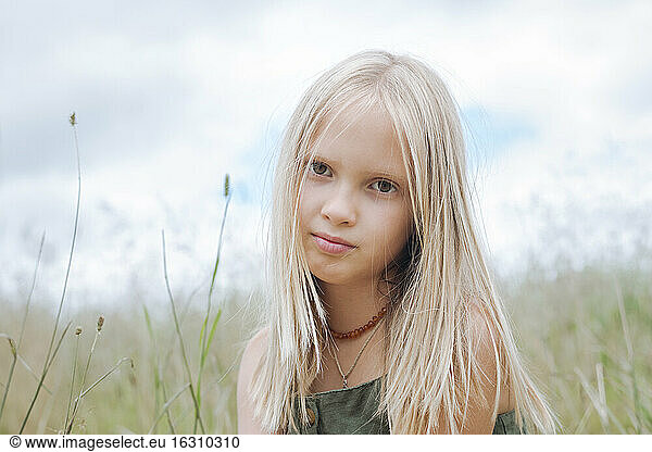 Portrait of blond girl in field