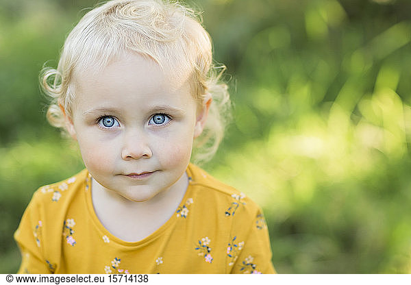 Portrait of blond toddler girl with blue eyes