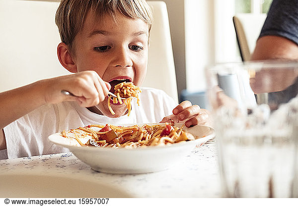 Portrait of boy eating Spaghetti