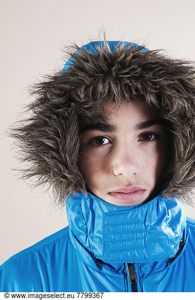 Portrait of Boy in Winter Jacket with Faux Fur Trimmed Hood in Studio