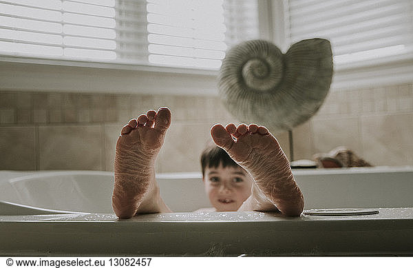 Portrait of boy taking bath in bathtub