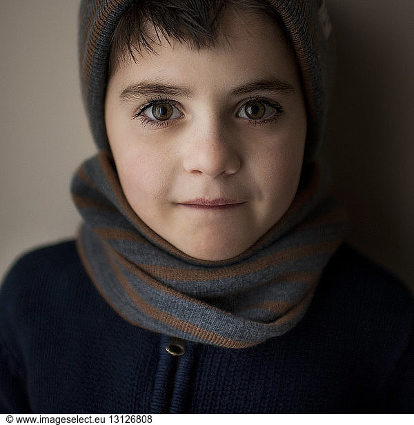 Portrait of boy wearing warm clothing at home