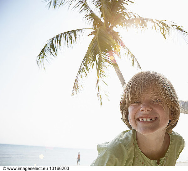 Portrait of boy with toothy grin on beach  Rawa Island Malaysia