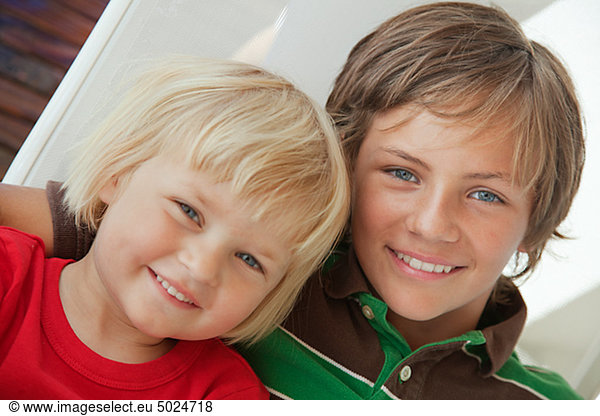 Portrait of brother and sister posing together and smiling