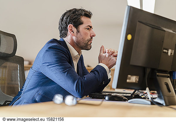 Portrait of businessman at desk in office
