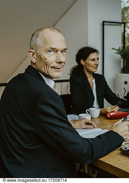 Portrait of businessman at desk in office