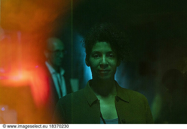 Portrait of businesswoman in illuminated exhibition center