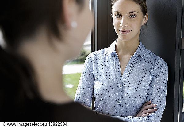 Portrait of businesswoman meeting colleague in office