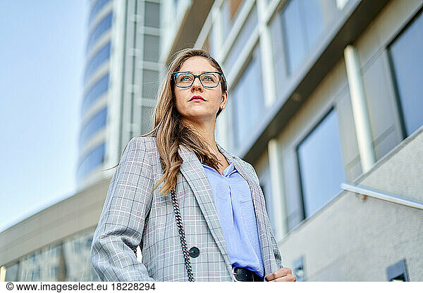 Portrait of businesswoman on bridges between office buildings