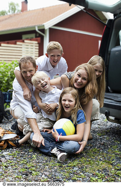 Portrait of cheerful family enjoying holiday outdoors