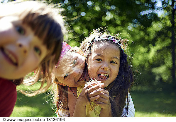 Portrait of cheerful girls during birthday celebration at park
