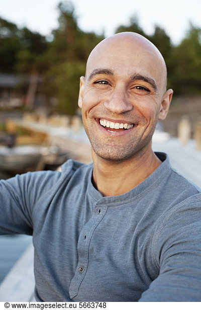 Portrait of cheerful man smiling while looking at you