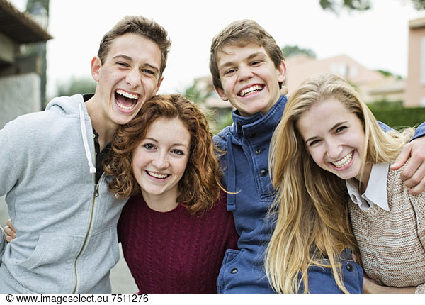 Portrait of cheerful young friends standing together