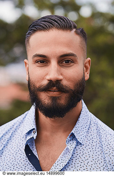 Portrait of confident bearded man at party