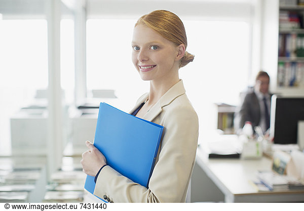 Portrait of confident businesswoman holding folder