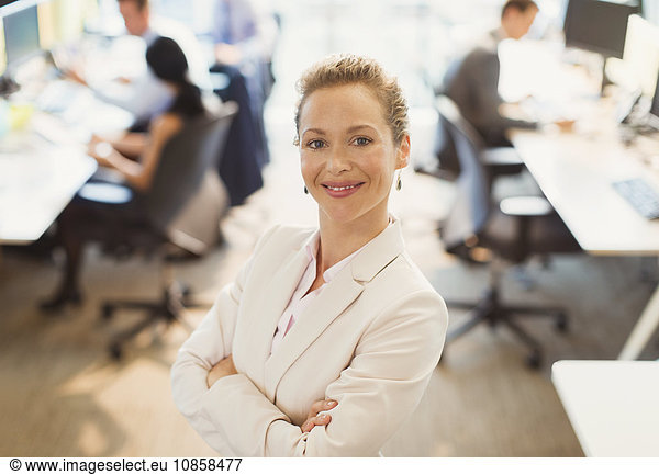 Portrait of confident businesswoman with arms crossed in office